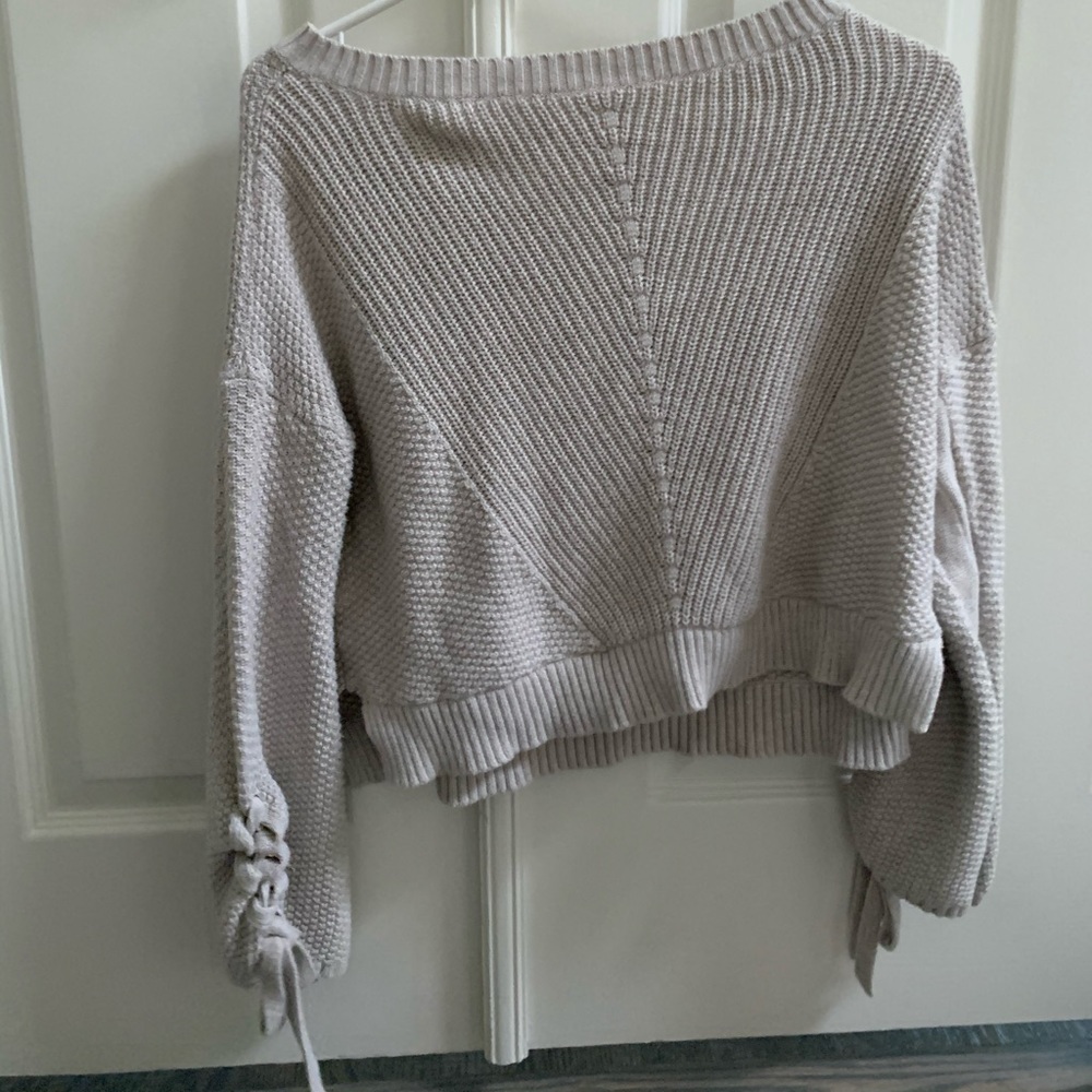 Cropped sweater with braided detailing on arm